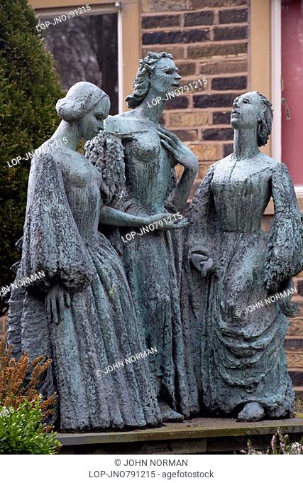Bronze statue of the Bronte sisters in the grounds of the Parsonage Museum