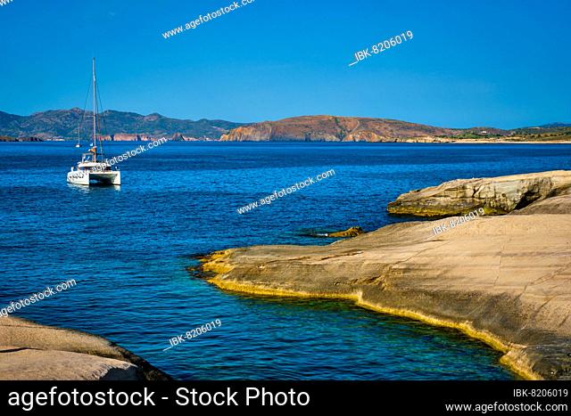 Yacht boat in Aegean sea at white rocks of Sarakiniko Beach, Milos island, Greece, Europe