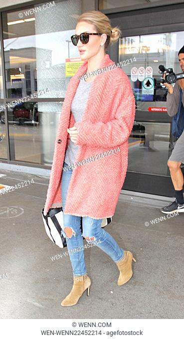 Rosie Huntington-Whiteley arrives at Los Angeles International Airport (LAX) wearing a large pink coat Featuring: Rosie Huntington-Whiteley Where: Los Angeles