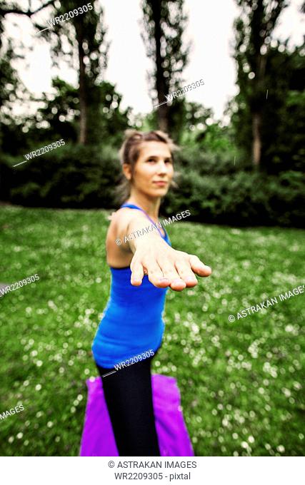 Determined woman doing yoga at park