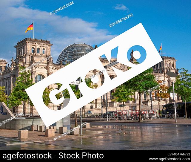 GroKo (short for Grosse Koalition, meaning Grand Coalition) superimposed to the Reichstag houses of parliament in Berlin, Germany
