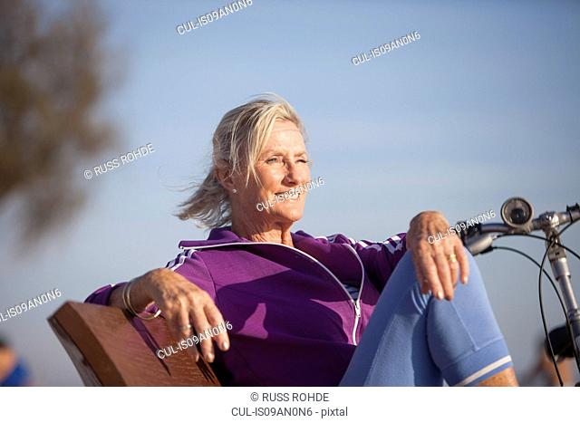 Senior woman enjoying ocean view on bench
