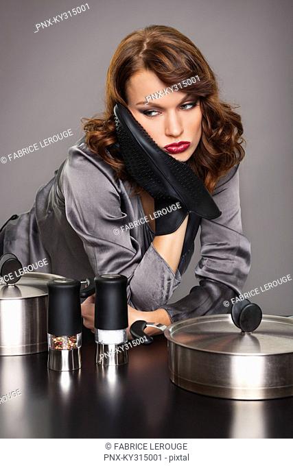 Young woman looking disappointed, cooking