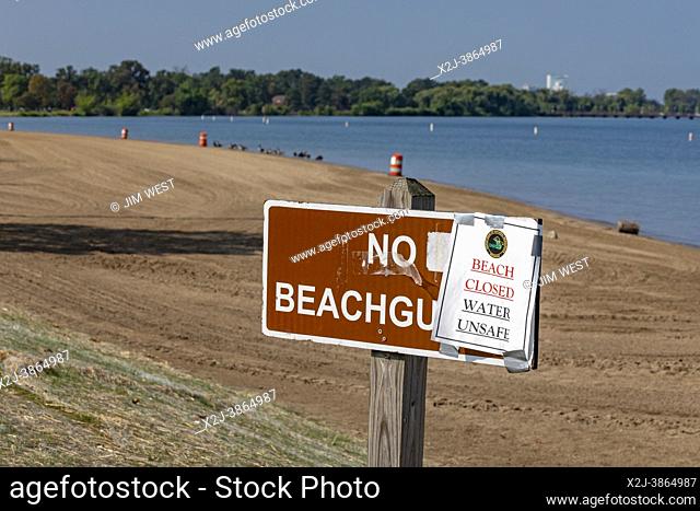 Detroit, Michigan USA - 28 August 2021 - As a heat wave sweeps across Michigan, a sign warns of unsafe water conditions at the Belle Isle Beach in the Detroit...