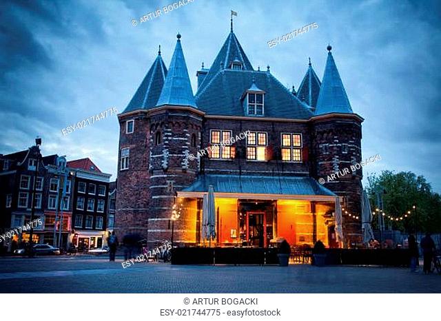 The Waag on Nieuwmarkt Square at dusk in Amsterdam, Holland, Netherlands. Built in 1488 as a city gate