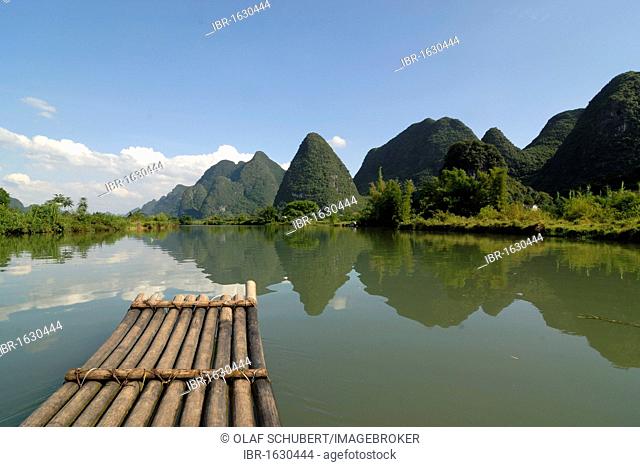 Bamboo raft on the Yulong river in the karst landscape near Yangshuo, Guilin, Guangxi, China, Asia