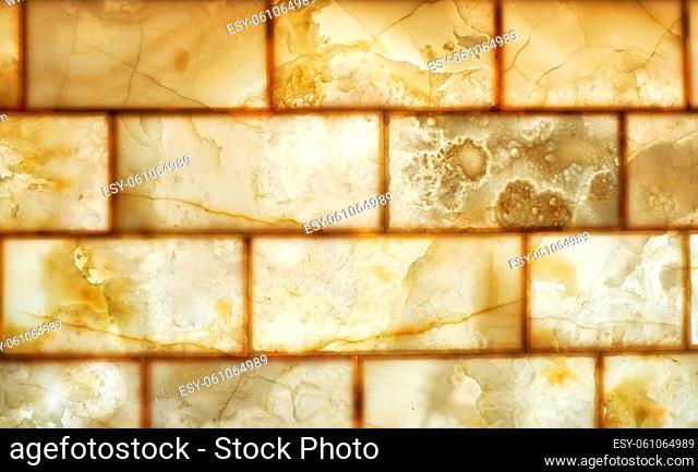 Onyx brick wall background. Texture of honey color onyx material
