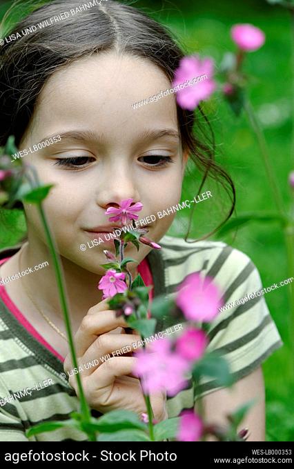 Girl smells at a spring flower