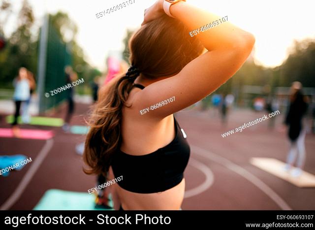 Attractive sport woman sports field and looking away. Sport girl resting after hard training
