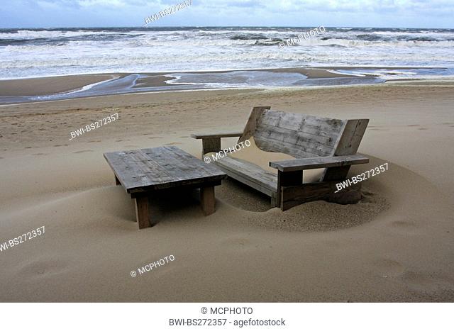 wooden bench and table at the sand beach in front of stormy sea, Germany, Schleswig-Holstein, Sylt