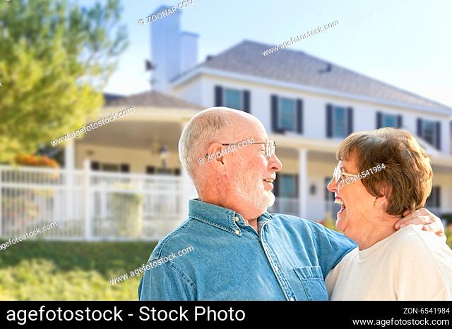 Happy Senior Couple in the Front Yard of Their House