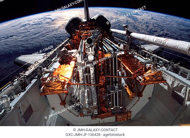 The horizon of a blue and white Earth and the blackness of space form the backdrop for this view of the cargo bay of the Space Shuttle Columbia