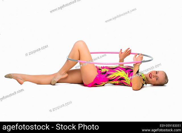 beautiful blond teen age gymnast girl making exercises with hula hoop. Studio shot isolated on white background. Copy space