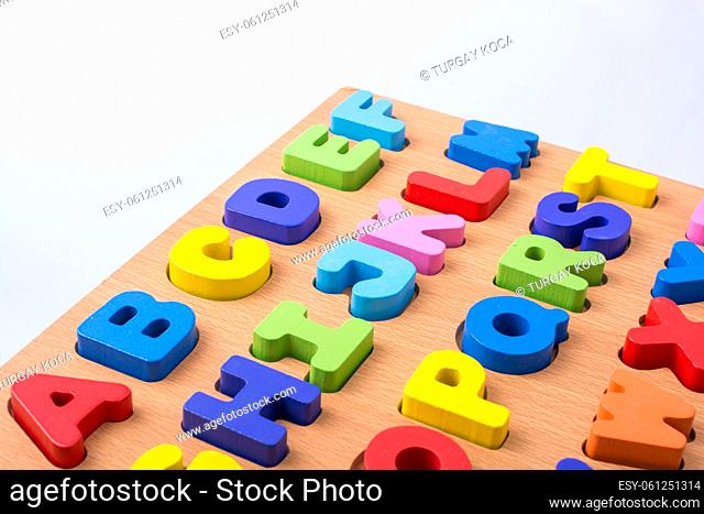 Colorful letter blocks on board on white background