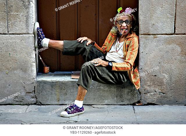 Old woman in doorway smoking a cigar, Havana, Cuba
