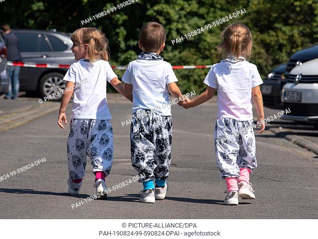 24 August 2019, Hessen, Lich: The three-year-old Joy (l-r), Nick and Stella from Leidhecken are on their way to the triplet meeting of the Hessian Prime...