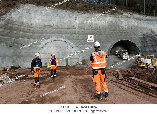 27 March 2019, Hessen, Sontra-Wichmannshausen: After the symbolic blasting for a new tunnel construction, tunnel builders stand in front of the stop wall