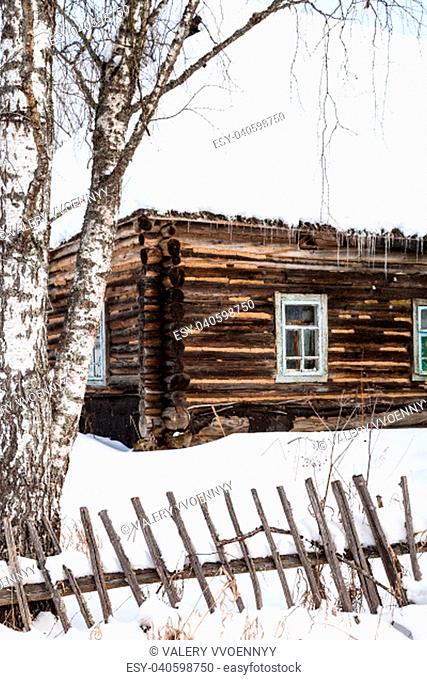 old abandoned russian wooden rural house in winter in little village in Smolensk region of Russia