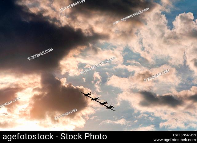 Aerobatics planes flying in the sky with clouds in the background