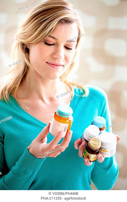 Woman taking food supplement