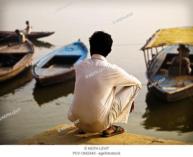 The Ganges, Varanasi, India, Rear view of a man at water's edge