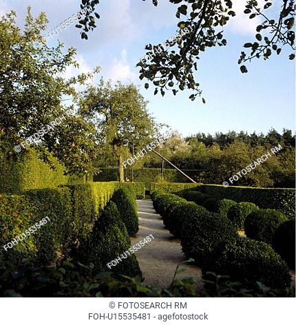 Clipped hedges in formal country garden in summer