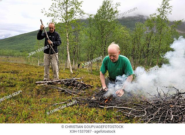 man making a campfire, Nordmannvikdalen valley, region of Lyngen, County of Troms, Norway, Northern Europe