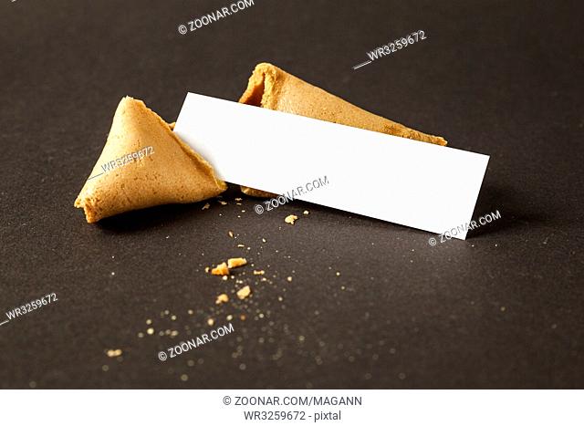An image of a fortune cookie with a blank paper for your message