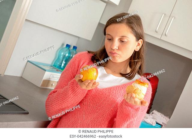 a teenage girl with sweet pastry and organic apple