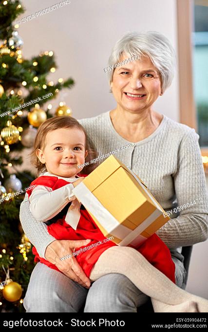 grandmother and baby girl with christmas gift