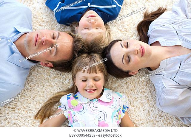 Family lying in a circle on the floor