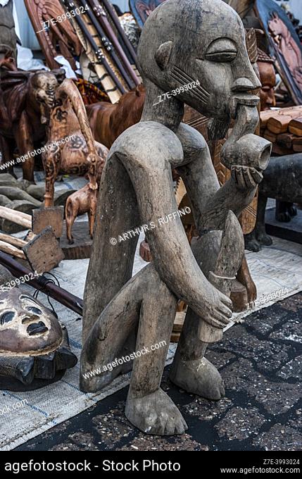 Shopping for traditional crafts: woodcarvings. Lomé, Togo, West Africa