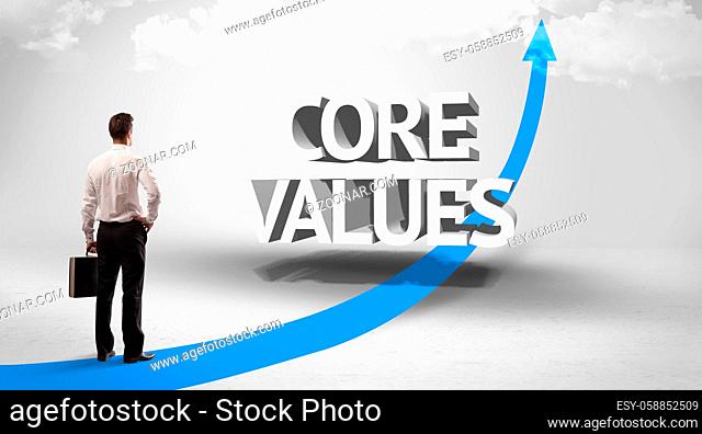 Rear view of a businessman standing in front of CORE VALUES inscription, successful business concept