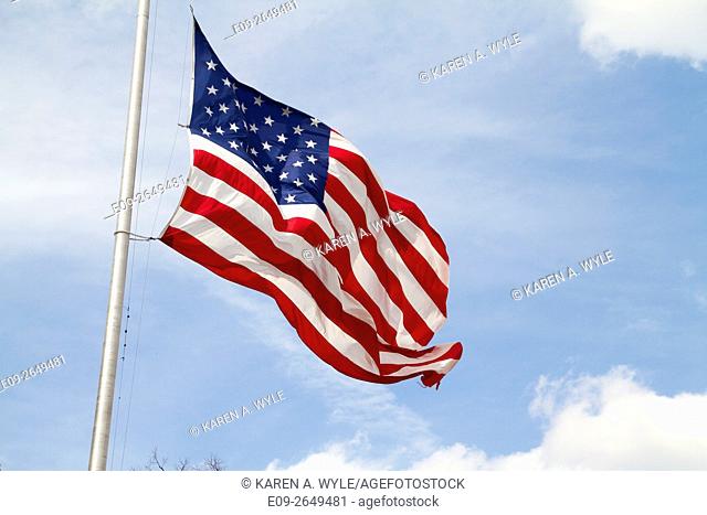 American flag rippling in the wind against partly blue, partly cloudy sky, Bloomington, Indiana