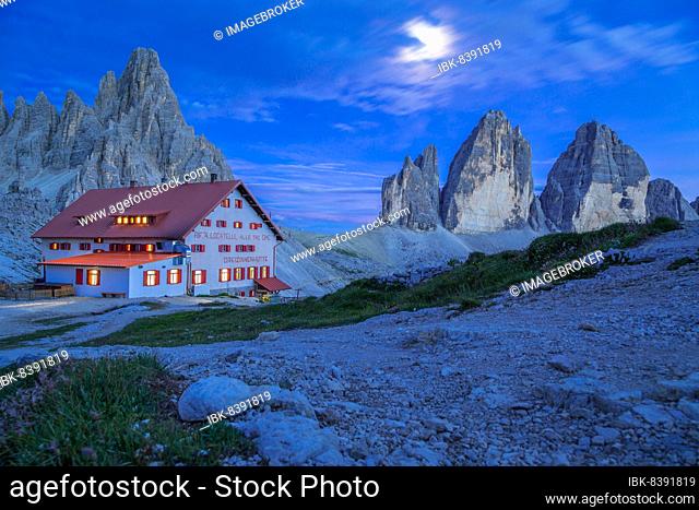 Mountain hut Dreizinnenhütte with rock massif Paternkofel and mountains three peaks at night, Dolomites, South Tyrol, Italy, Europe