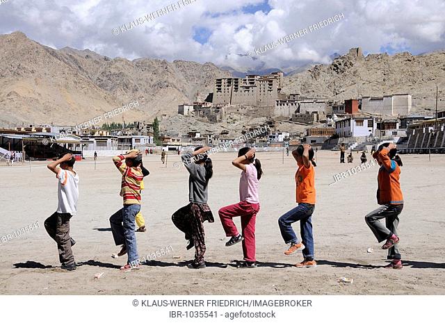 Ladakhi pupils training the march after an Indian school tradition in front of Leh Palace, Ladakh, North India, Himalaya, Asia
