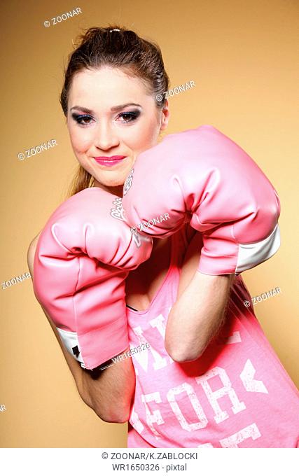 Female boxer model with big fun pink gloves
