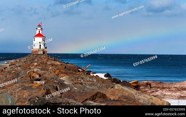 A rainbow forms as a storm clears the area at Superior Entry Lighthouse close to the Minnesota Wisconsin border USA