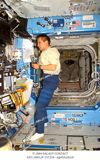Astronaut Edward T. Lu, Expedition 7 NASA ISS science officer and flight engineer, works in the Destiny laboratory on the International Space Station (ISS)