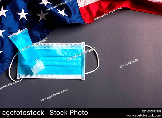 Medical protective disposable face mask for cover mouth and America flag, studio shot on gray background, Safety healthcare medical prevent coronavirus or...