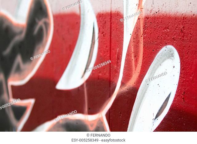 Red Letter Graffiti wall with depth of field in spanish street