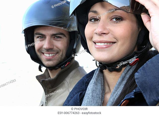 Couple wearing motorbike helmets