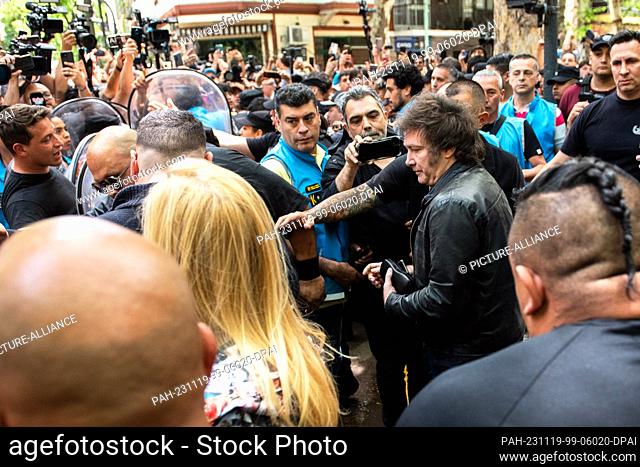 19 November 2023, Argentina, Buenos Aires: Javier Milei (center r), libertarian populist and presidential candidate, leaves the Almagro campus at the National...
