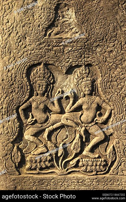 Two Apsara dancers carved into pillars at the Bayon temple of Angkor Thom