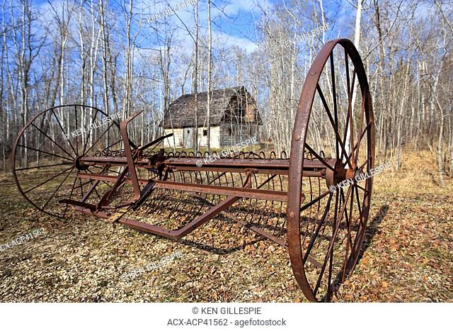 Abandoned plow and log barn, on the Kudlowich Prairie Homestead. Birds Hill Provincial Park, Manitoba, Canada
