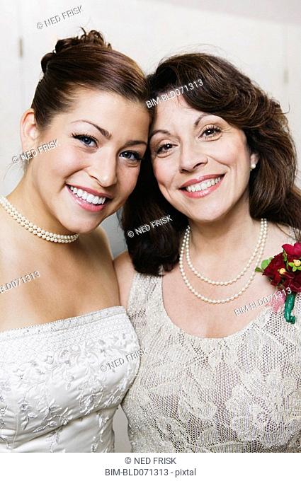 Bride and mother hugging