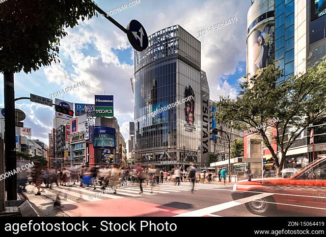 Wide view of the Shibuya Crossing Intersection in front of Shibuya Station on a bright summer day