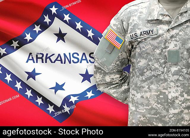 American soldier with US state flag on background - Arkansas