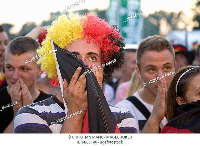 Fan wearing a wig with the colours of the German flag watching the final game of the football EM on the Berlin fan mile, Berlin, Germany, Europe