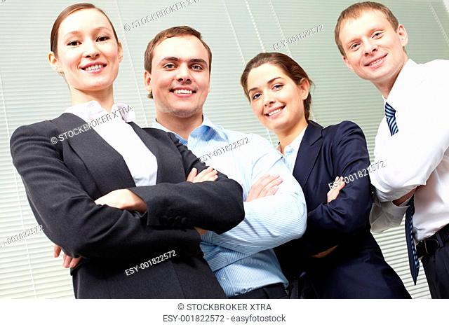 Portrait of four smiling confident business people